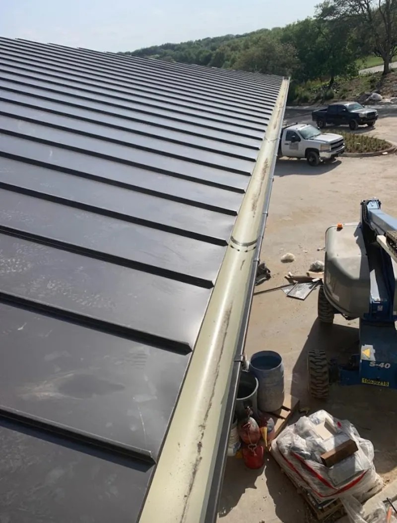 Standing seam panel and gutter detail on a metal roofing jobsite in Williamsburg